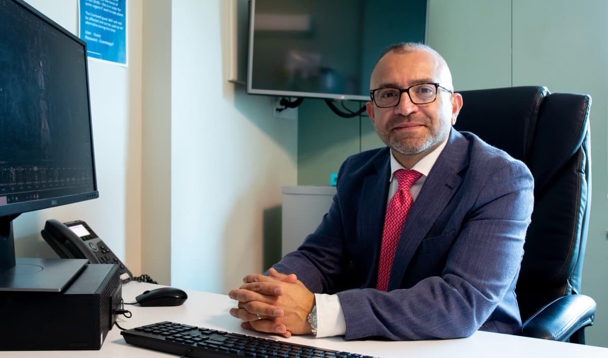 Mr Mohiemen Anwar at his consulting room desk